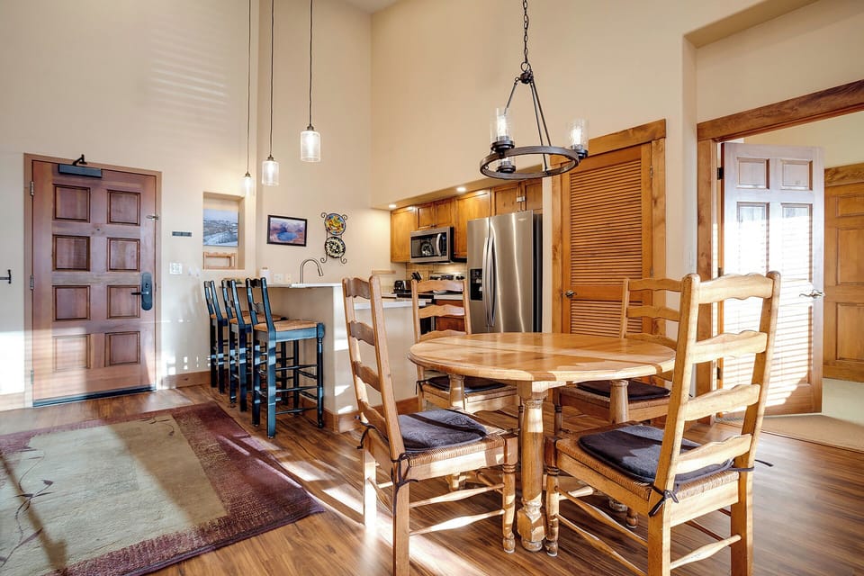 Step into your open-concept haven where rustic charm meets modern comfort—gather around the handcrafted dining table for memorable meals.