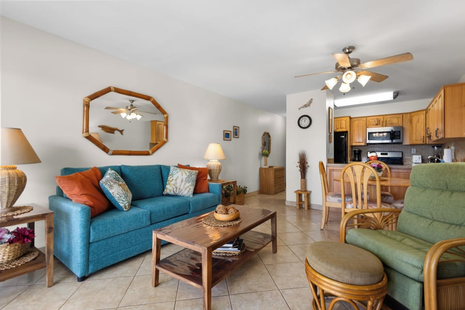 Step into your bright, open-plan living space where coastal colors and cozy furnishings invite you to relax after a day of adventure. The fully equipped kitchen makes meal prep a breeze.