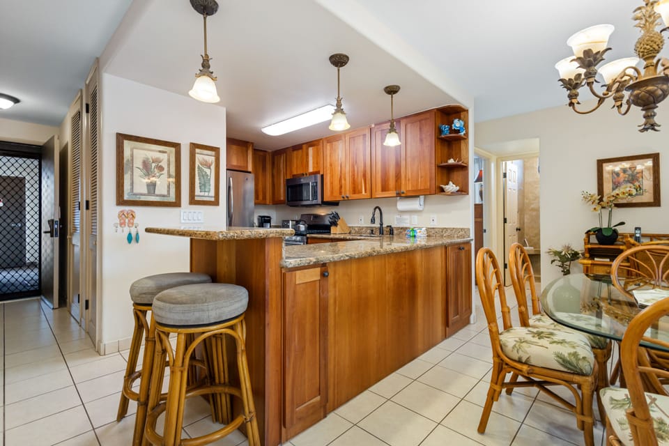 Picture yourself preparing your favorite meals in this inviting kitchen, complete with warm wood cabinetry, granite counters, and stainless appliances—your home away from home awaits.