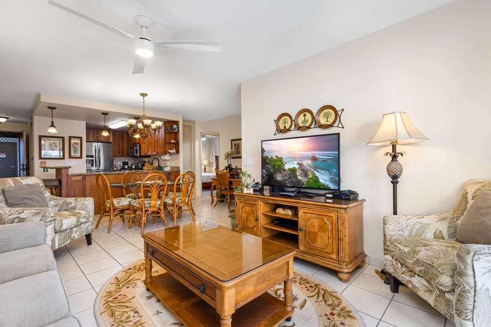 Unwind in your spacious living area, where warm wood tones meet coastal comfort. Relax on plush seating, enjoy your favorite shows, and savor meals together in this inviting open-plan retreat.
