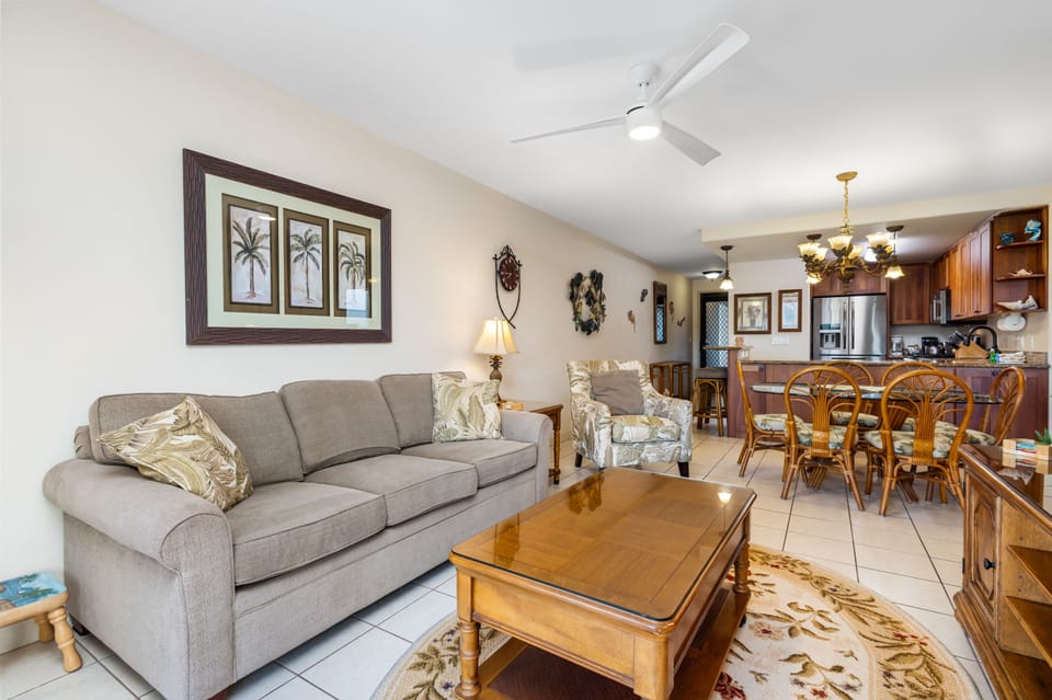 Relax in this inviting open-concept space where soft island breezes from the ceiling fan cool you while you unwind on comfortable seating. The living area flows seamlessly into your fully-equipped kitchen and dining area.