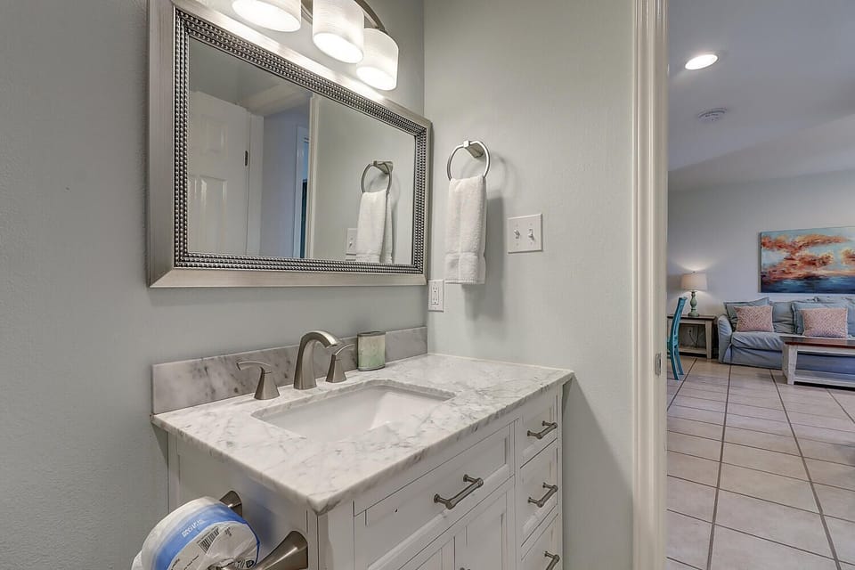Freshen up in your elegant bathroom featuring marble countertops, modern fixtures, and fluffy towels—perfect for unwinding after a day of exploring.