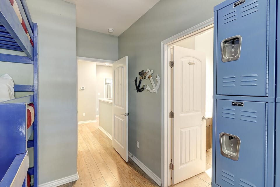 Indoor - Bunk room featuring 6 cozy twin beds and an attached shared en-suite bathroom