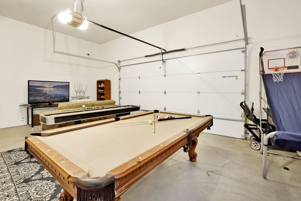 A fun game room with games perfect for family fun, friendly competition, and unforgettable entertainment during your stay. The space also features comfy seating and a TV, making it a great spot to relax and enjoy time together.