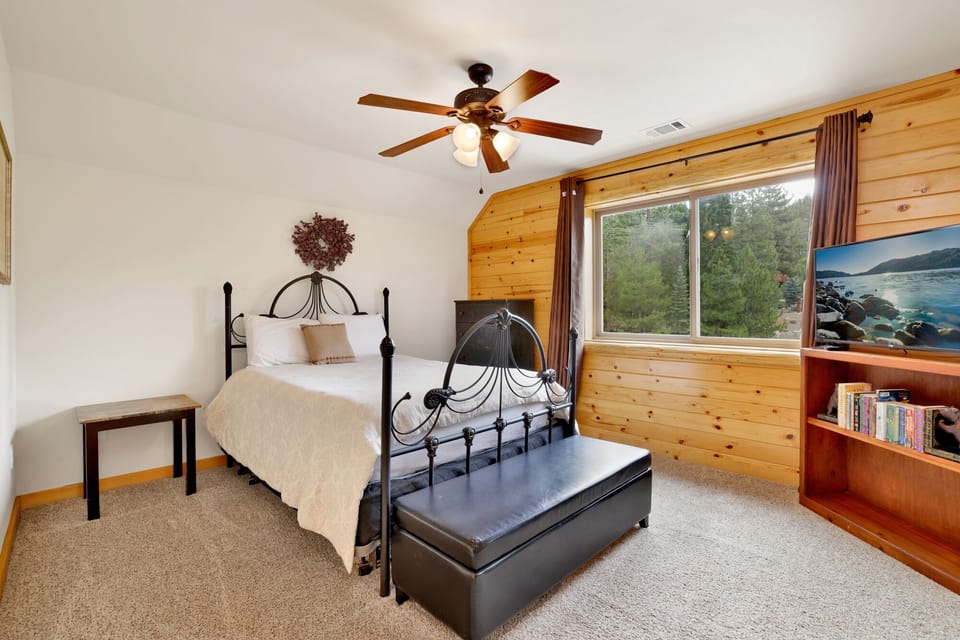 Peaceful cabin bedroom with plush bedding, and beautiful views—ideal for restful nights, cozy mornings, and a relaxing mountain escape.
