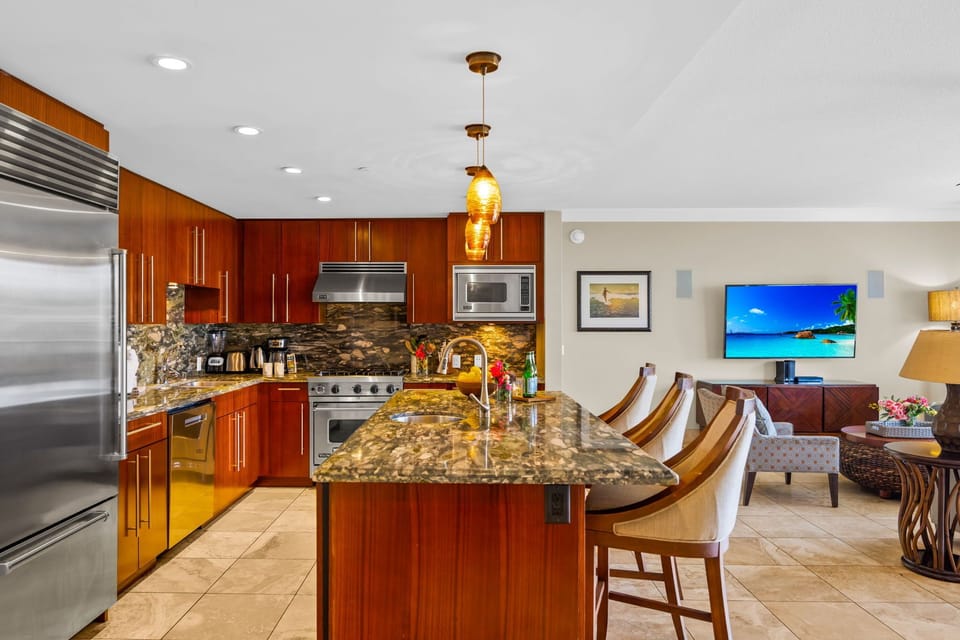 Warm wood cabinetry, stone countertops, and a wide prep island make cooking easy and social.