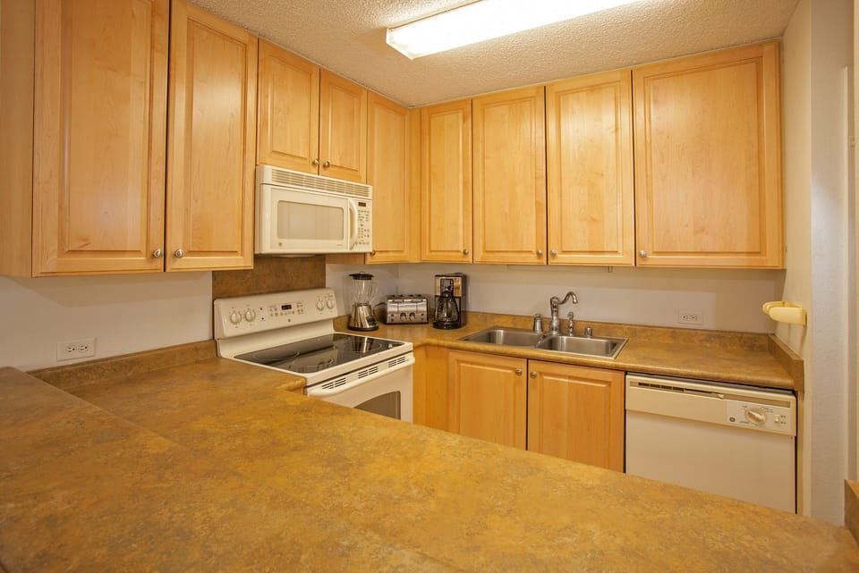 Cook your favorite meals in this fully equipped kitchen, featuring ample counter space, modern appliances, and plenty of storage for all your culinary needs.