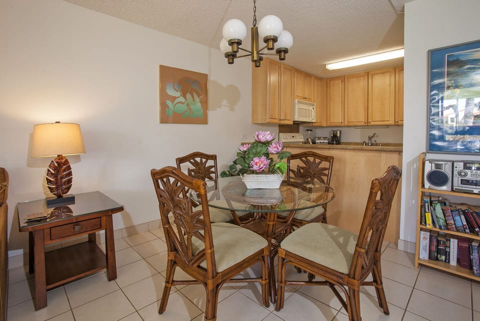 Step into this inviting dining and kitchen space, where tropical-inspired décor meets home comfort. Gather around the elegant glass-top table, prepare meals in your fully equipped kitchen, and enjoy a relaxing retreat.