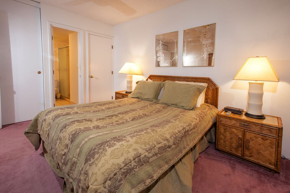 Unwind in this peaceful bedroom with its inviting bed, warm lighting, and calming artwork—your restful retreat after a day of adventure.