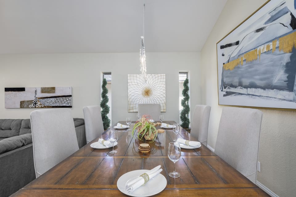 The dining area has a large table and comfortable chairs.