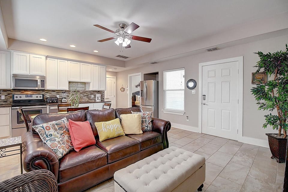 Relax on your plush leather sofa while the full kitchen awaits your culinary adventures in this bright, open-concept space.