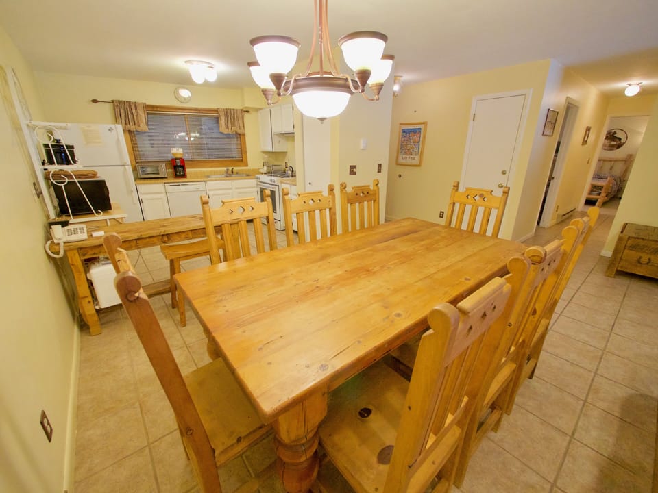 Large Dining and Kitchen Area - The large dining room table is wonderful for the entire party. The dining area opens up into the fully equipped kitchen and living room.