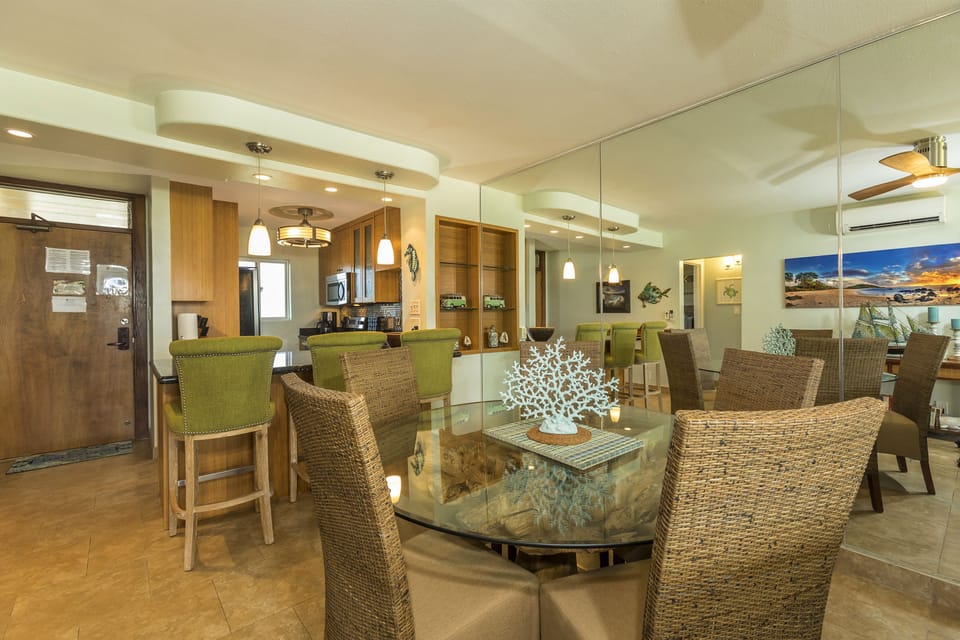 Gather around this beautifully designed open-concept living and dining space, where coastal-inspired decor meets modern comfort. Natural light fills the room through ocean-view windows, creating your perfect island retreat.
