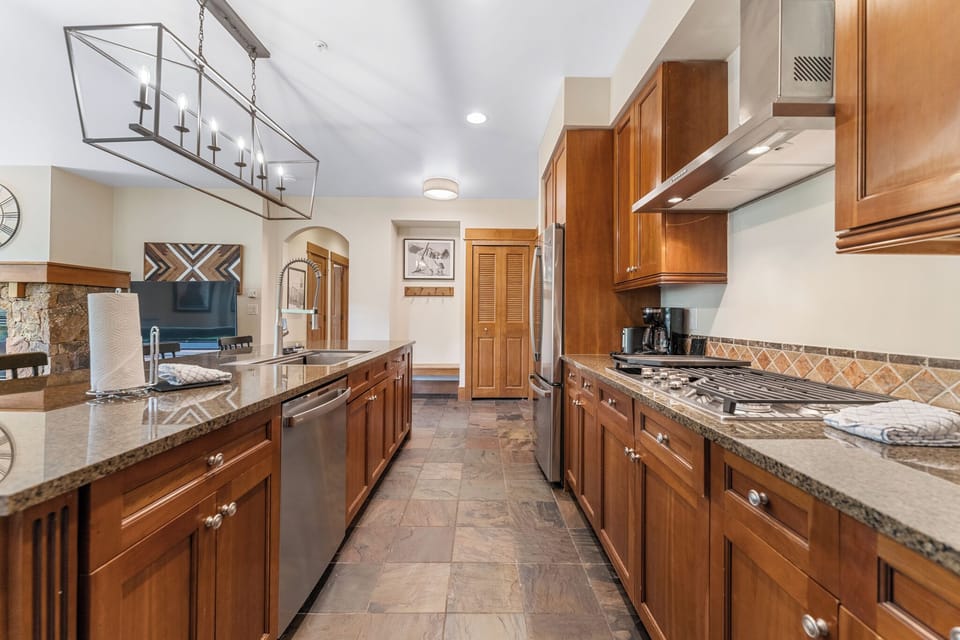 Your gourmet kitchen awaits with rich wood cabinetry, granite counters, and professional appliances for memorable meal preparation.