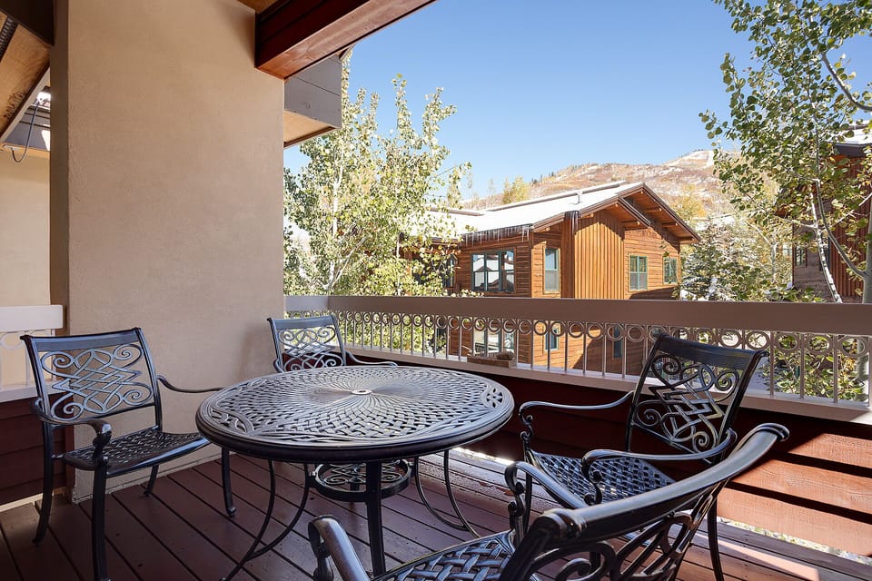 Enjoy morning coffee on your private balcony with elegant wrought iron furniture and stunning mountain views.