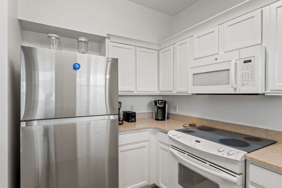 Your modern kitchen features stainless steel appliances and sleek white cabinets, perfect for preparing meals during your stay.