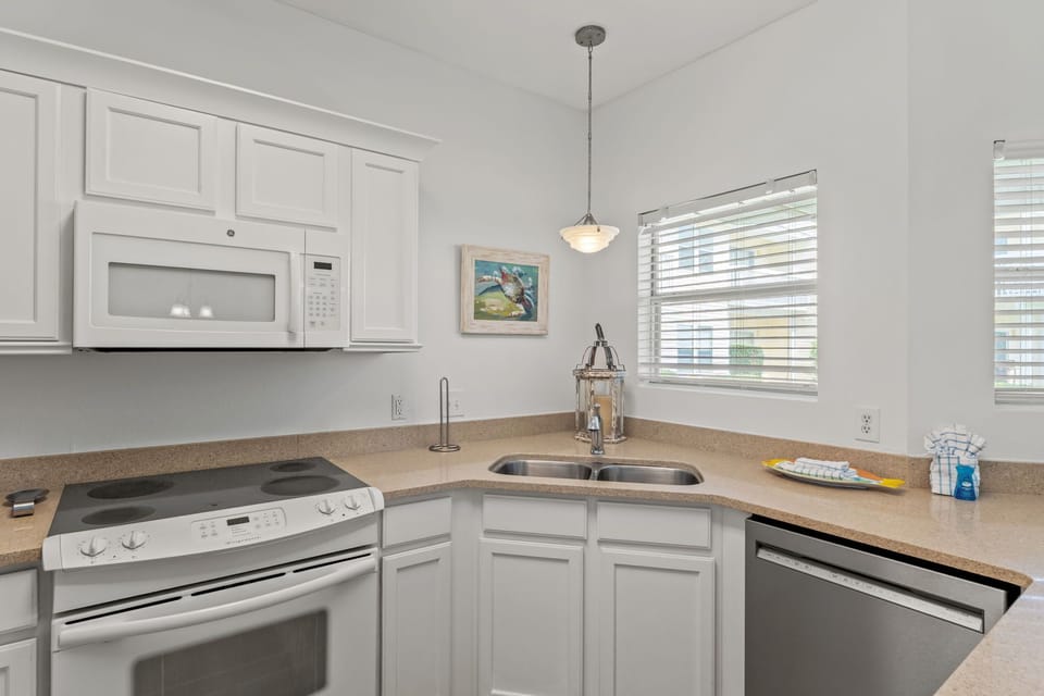 Your bright kitchen features modern appliances and granite counters, perfect for preparing meals with natural light streaming in.