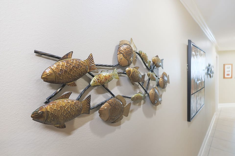 Admire the charming fish decor along the hallway, setting a fun coastal vibe for your beach getaway