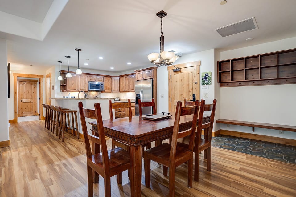 Gather around your spacious dining table while the chef prepares meals in your fully-equipped kitchen with rich wood finishes.