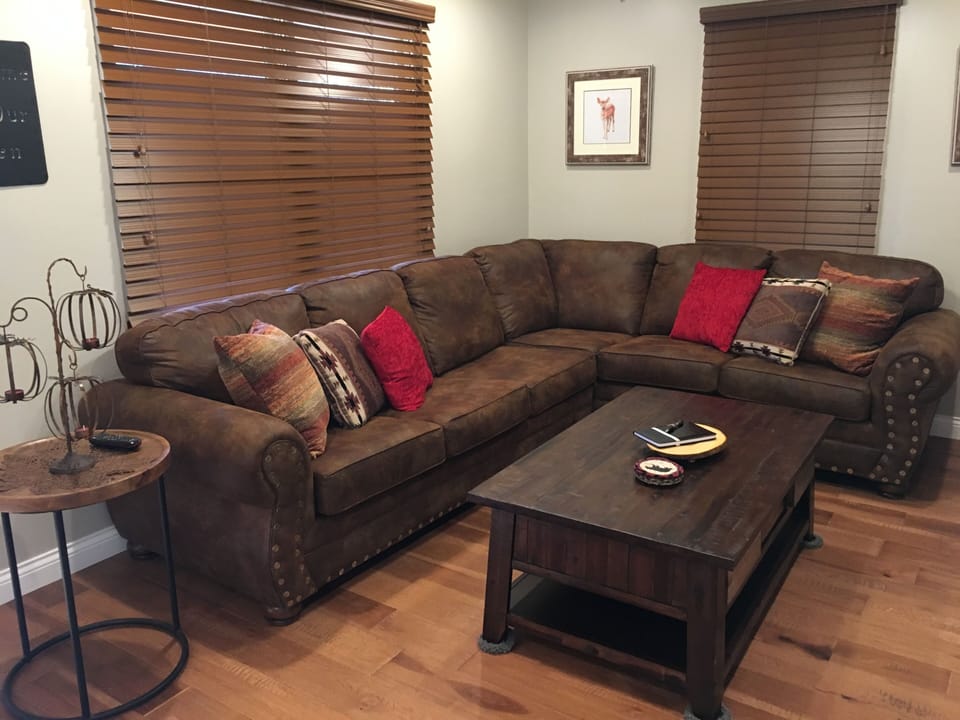 Living room area with sectional sleeper sofa.  55 inch flat screen with DISH