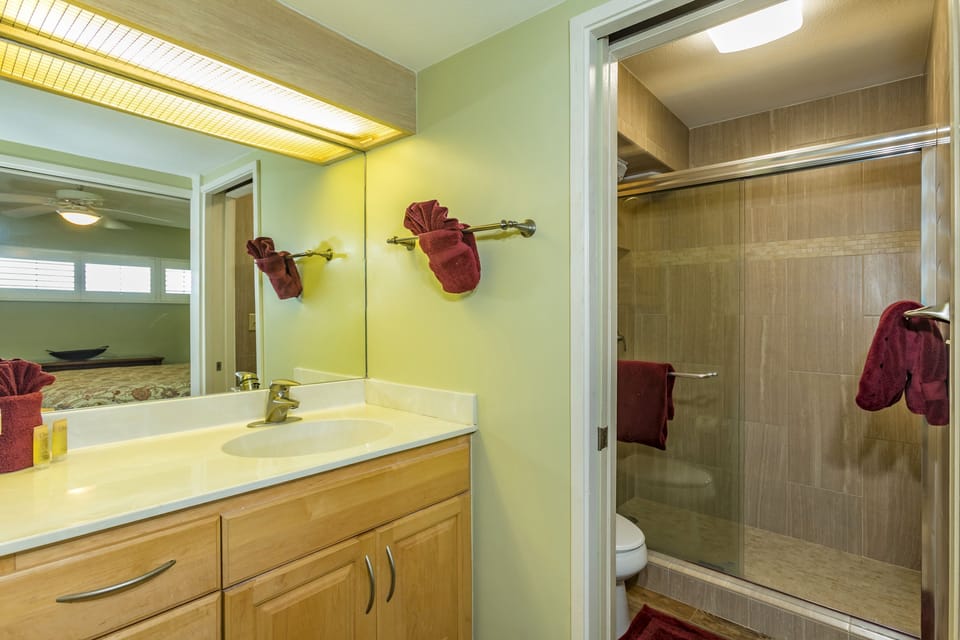 Step into your private retreat featuring a spacious vanity and walk-in shower. The soft lighting and warm tones create a spa-like atmosphere perfect for unwinding after a day of adventure.
