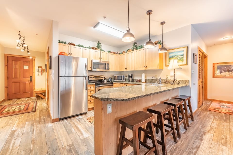 Your fully-equipped kitchen awaits with granite counters, stainless appliances, and a breakfast bar where you can savor morning coffee together.