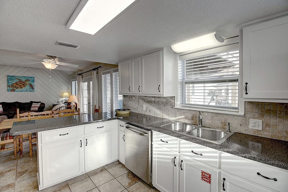 Your fully-equipped kitchen features granite countertops, stainless appliances, and ample prep space for creating memorable meals during your stay.