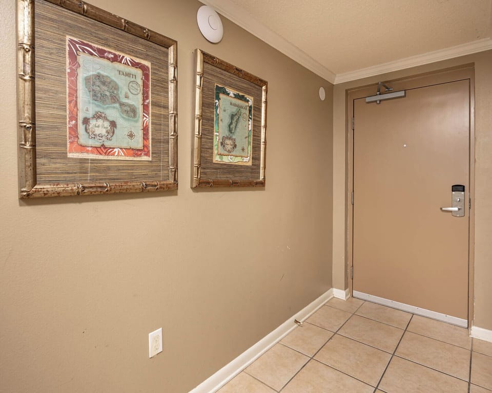 Step into a welcoming entryway adorned with charming artwork and tiled flooring, setting the tone for your stay