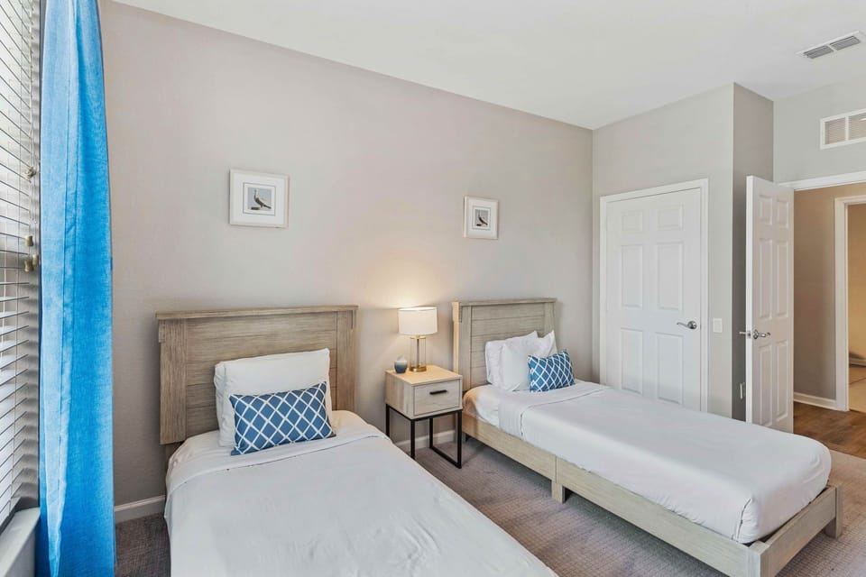 Discover comfort and versatility in Bedroom 2, featuring two cozy twin beds, perfect for accommodating guests or family members with individual sleeping preferences. Enjoy a peaceful night's rest in this inviting space, designed for ultimate comfort