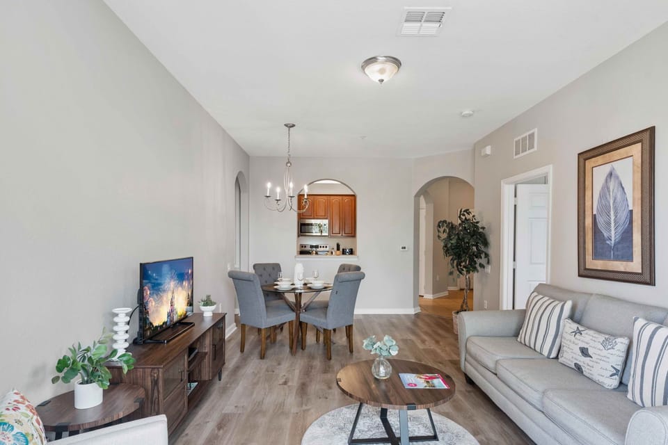 Cosmopolitan Comfort: Unwind in our living area, featuring a sleek kitchen and a dining space, designed for both stylish entertaining and everyday living
