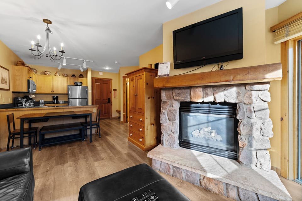 Cozy up by your stone fireplace while dinner simmers in the full kitchen—this warm space perfectly blends rustic charm with modern convenience.