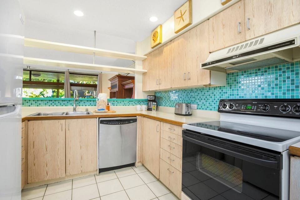 This breezy kitchen pops with aqua tiles, beachy wood tones, and sunny charm perfect for island-inspired cooking   