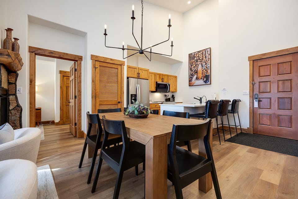 Gather around your spacious dining table where warm wood tones and modern comfort create the perfect setting for memorable meals together.