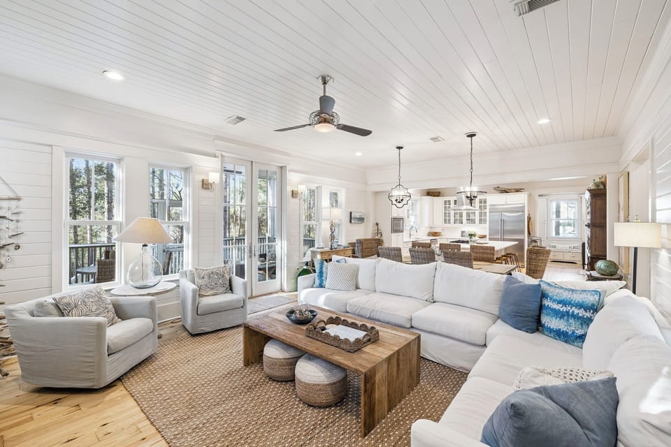 Unwind in your bright, coastal living space featuring plush seating and an open flow to your private dining area and kitchen.