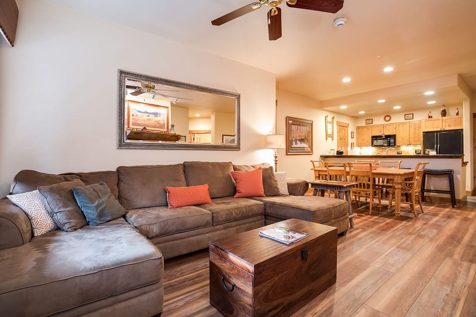 Sink into the plush sectional sofa and feel at home in this open-concept space where comfort meets mountain charm.