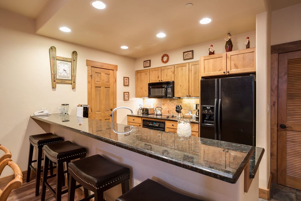 Your fully-equipped kitchen features granite counters, quality appliances, and a breakfast bar perfect for morning coffee or casual meals together.
