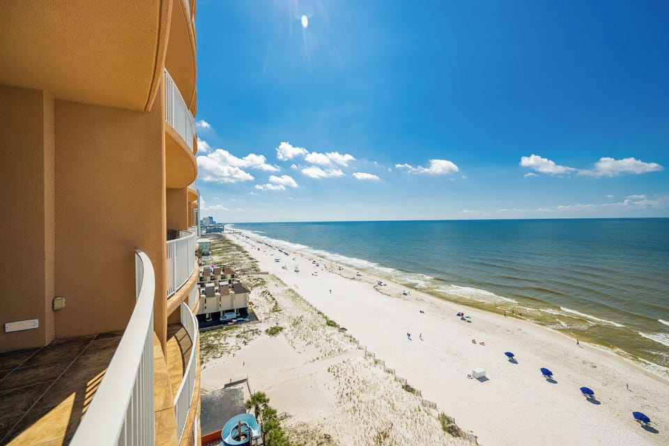Enjoy breathtaking views from the balcony, overlooking the shoreline and inviting waters, perfect for relaxation