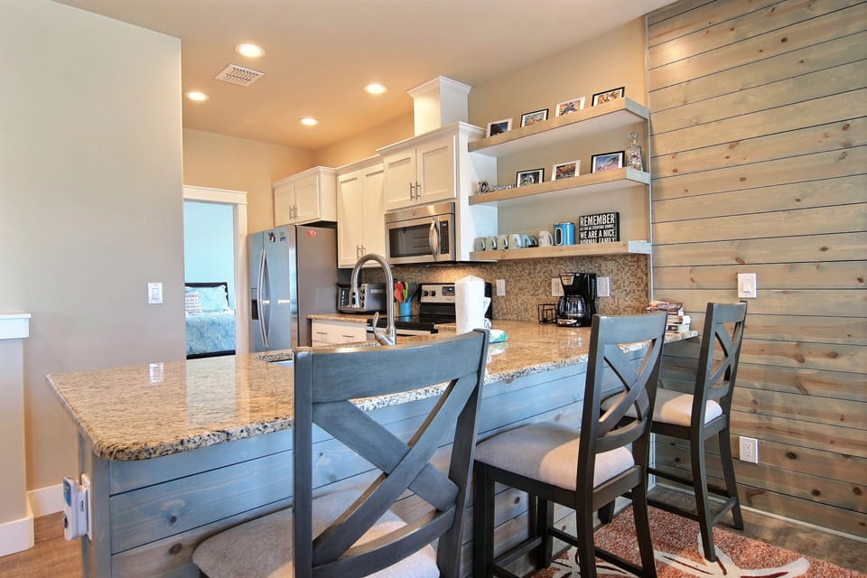 Kitchen - Kitchen island bar equipped with bar seating inviting guest to enjoy breakfast together