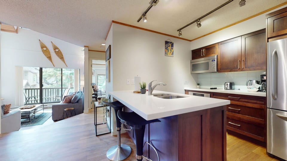 A central hub for gathering, the kitchen blends seamlessly with the dining and living areas.