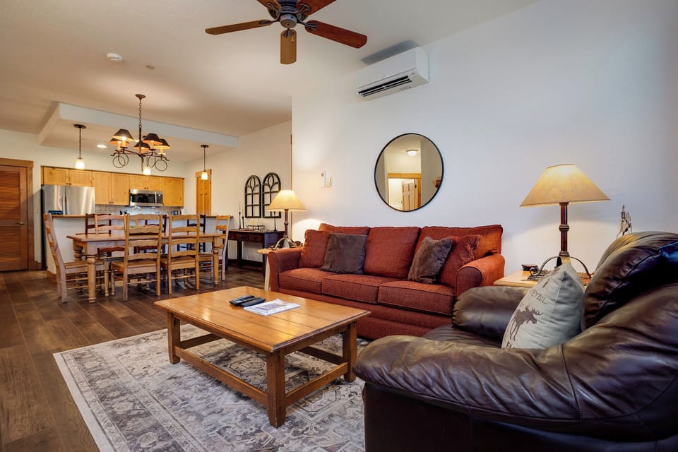 Relax in your spacious open-concept living space with plush seating, modern kitchen, and climate control for your comfort.