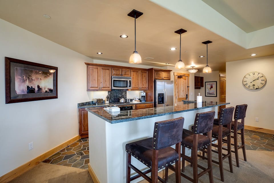 Your gourmet kitchen features granite countertops, stainless steel appliances, and a spacious breakfast bar perfect for morning coffee.