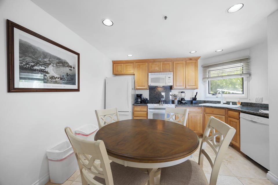 Your fully equipped kitchen invites home-cooked meals with modern appliances, granite counters, and a welcoming dining table where you can savor breakfast.