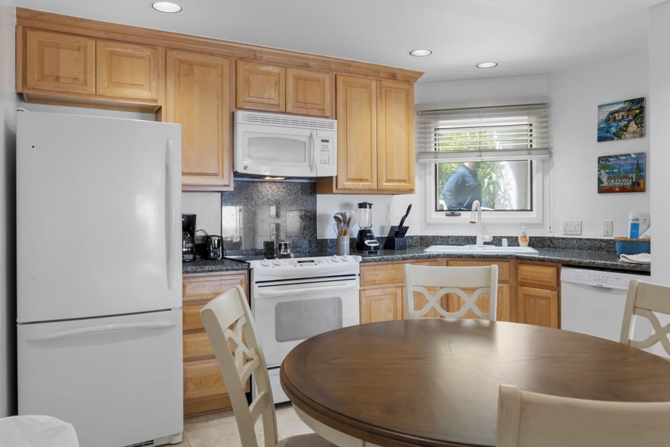 Your fully-equipped kitchen features granite counters, warm wood cabinets, and everything needed for home-cooked meals together.