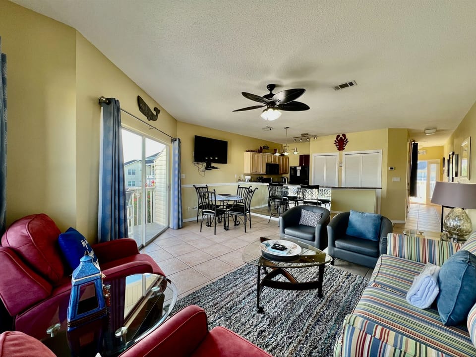Unwind in your spacious open-concept living area where colorful coastal furniture and plenty of seating create the perfect gathering spot for family memories.