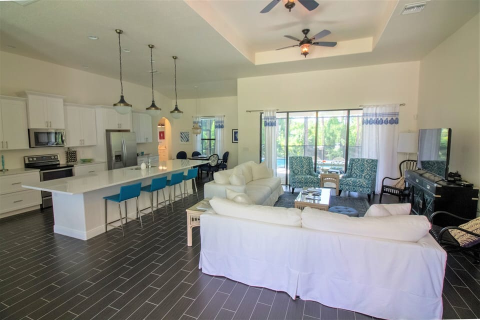 Large open great room with 12 foot slider to lanai and pool
