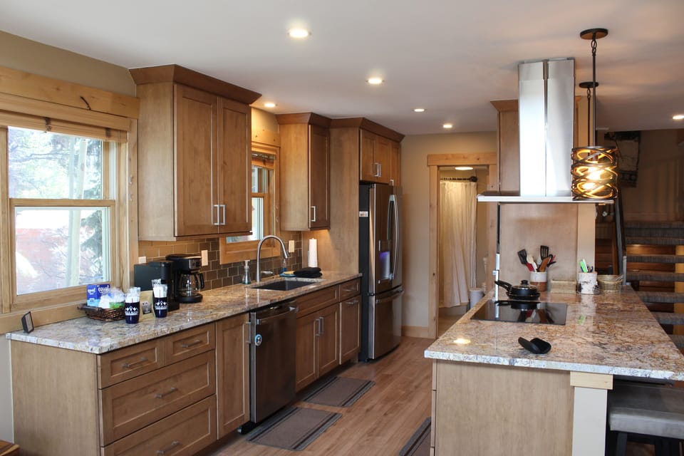 Kitchen - Seamlessly connects to the dining and living areas, making it ideal for entertaining or keeping conversations flowing while cooking. Updated appliances includes a microwave, range, refrigerator, and garbage disposer—all in a clean, modern finish that suits the remodeled interior.