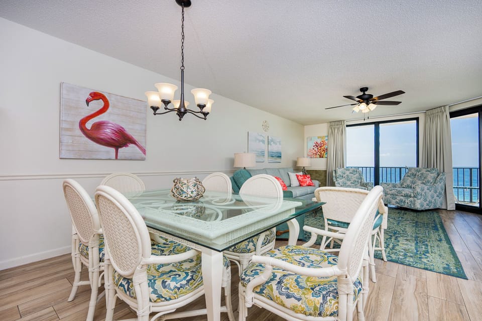Dine at the glass table surrounded by colorful chairs while enjoying the serene views from the spacious living area