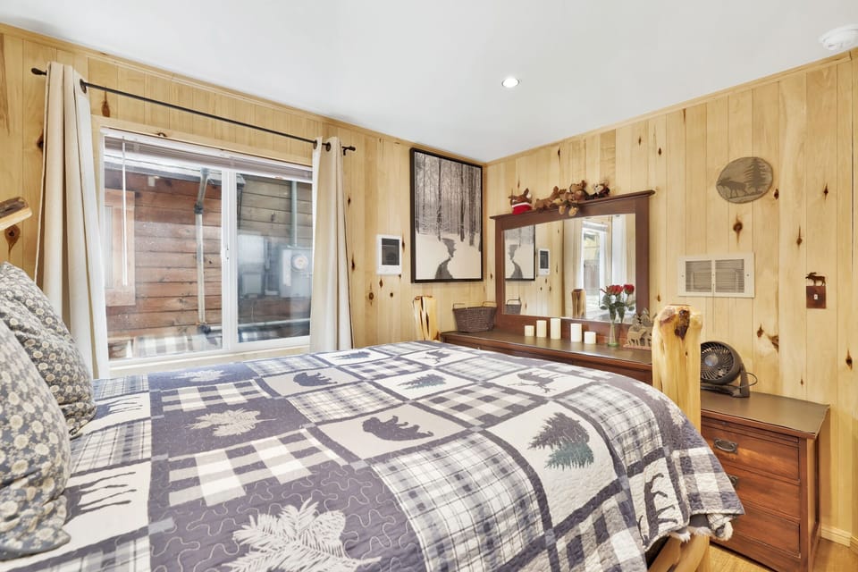 Peaceful cabin bedroom with plush bedding, and beautiful views—ideal for restful nights, cozy mornings, and a relaxing mountain escape.