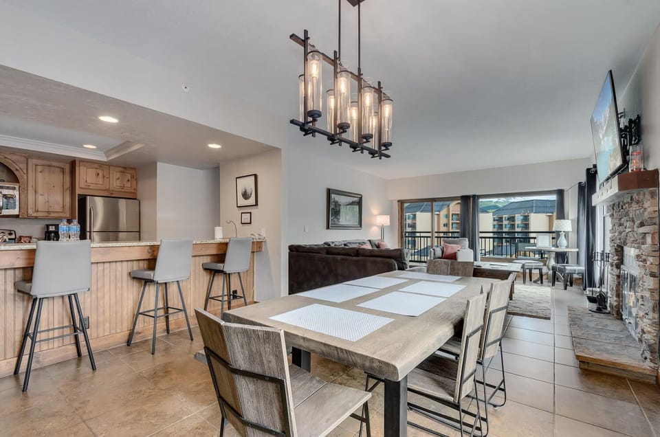 6-7 adults fit comfortably at the dining table, with 4 more seats at the counter