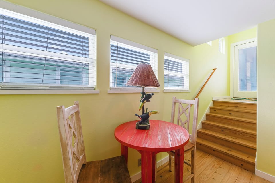 Enjoy your morning coffee or an evening chat in this cozy seating nook, filled with natural light and coastal charm.
